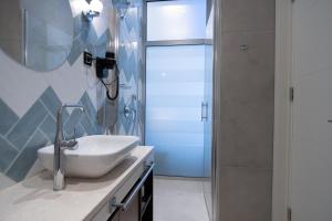 a bathroom with a sink and a shower at SL Panorama in Trebinje