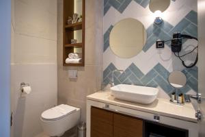 a bathroom with a sink and a toilet and a mirror at SL Panorama in Trebinje