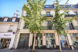 a building in paris with two trees in front of it at SAINT JACQUES - Logement Climatisé en Centre Ville in Reims