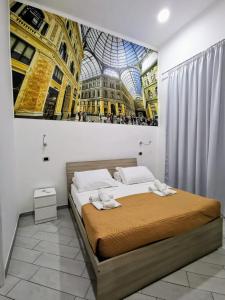a bedroom with a bed with a painting on the wall at DUOMO 152 NAPOLI in Naples