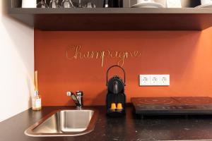 a kitchen counter with a stove and a sink at Luxstay Bad Nauheim - Self-Check-In in Bad Nauheim