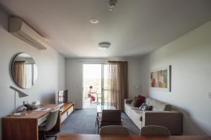 a living room with a couch and a table at Quest Toowoomba in Toowoomba