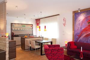 a living room with a table and chairs and a kitchen at Deluxe Apartment Sonnleitner - ADULTS ONLY in Furth