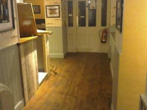 a hallway with a hallwaygueivating at Holland Hotel in Llanfachraeth