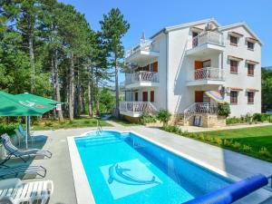 an apartment with a swimming pool in front of a building at Apartment Fuma-6 by Interhome in Jadranovo