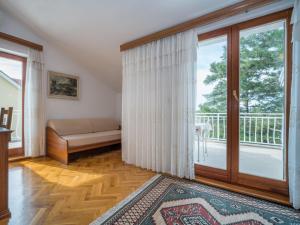 a living room with a couch and a large window at Apartment Fuma-6 by Interhome in Jadranovo