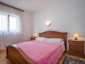 a bedroom with a large bed with a pink blanket at Apartment Fuma-3 by Interhome in Jadranovo +36 photos