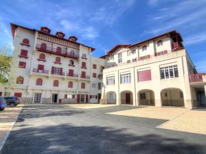 a large building with a parking lot in front of it at Apartment Du lac by Interhome in Soorts-Hossegor