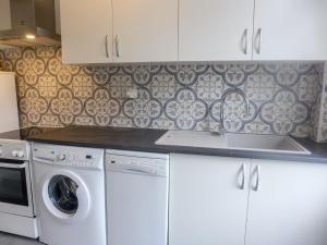 a kitchen with a washing machine and a sink at Apartment Du lac by Interhome in Soorts-Hossegor +14 photos