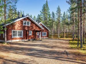 a log cabin in the woods with a large driveway at Holiday Home Kiepinkulma a by Interhome in Levi