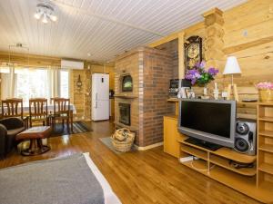 a living room with a television and a dining room at Holiday Home Viinakorpi by Interhome in Somerniemi