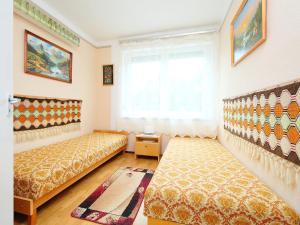 a bedroom with two beds and a window at Holiday Home Palma by Interhome in Balatonszárszó