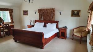 ein Schlafzimmer mit einem großen Bett und einem Stuhl in der Unterkunft The Down Inn in Bridgnorth