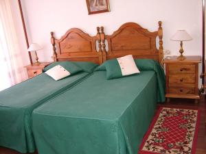 Un pat sau paturi într-o cameră la Hostal El Botero