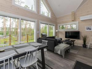 a living room with a table and a couch at Holiday Home Miilu by Interhome in Jyrkkä