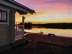 a house with a dock next to a body of water at Holiday Home Villa mari by Interhome in Pertunmaa