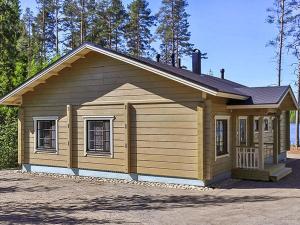 a small house with a garage in a parking lot at Holiday Home Villa mari by Interhome in Pertunmaa