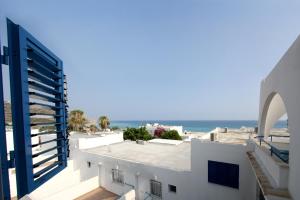 a view of the ocean from the balcony of a building at Pissouri Beach Apartments in Pissouri