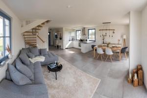 a living room with a gray couch and a table at Ferienhaus Lagom in Parow