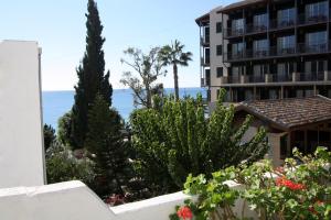 a view of the ocean from the balcony of a hotel at Pissouri Beach Apartments in Pissouri