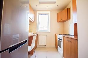 a small kitchen with a stove and a window at Studio16 in Nowy Sącz