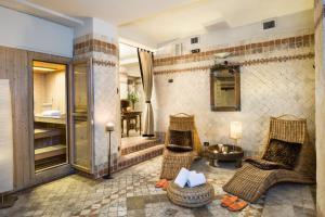 a bathroom with two chairs and a shower at Adler Cavalieri Hotel-Private Spa & Gym in Florence