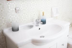 a bathroom with a sink with two candles on it at Best House, Marina Home, Athens Avenue, Patra in Patra +16 photos