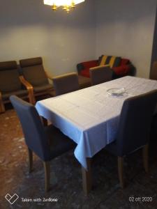 a table with chairs and a white table cloth on it at barbarigo in Padova