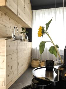 a kitchen with a table with a sunflower on it at ride & relax Aparthotel Schwarz in Eben im Pongau