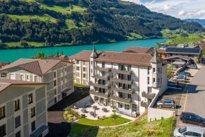 an aerial view of a hotel with a lake at Emma's B&B - Self Check-in Hotel in Lungern