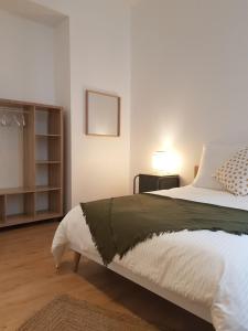 a bedroom with a large bed and a book shelf at Grand appartement, 3 chambres, centre de Dieppe in Dieppe
