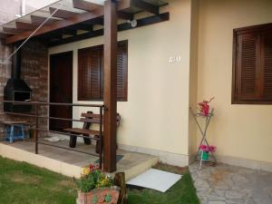 a porch of a house with a bench on it at RESIDENCIA CASELANI in Caxias do Sul