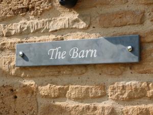 a sign on the side of a brick wall at The Croft Farm in Peterborough