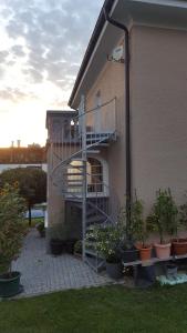 un edificio con una escalera y macetas en Ferienwohnung Zellner, en Deggendorf