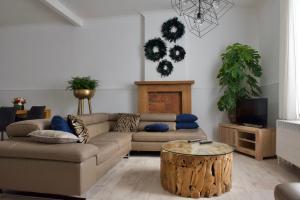 a living room with a couch and a coffee table at Vakantiewoning Oudsbergen in Opglabbeek