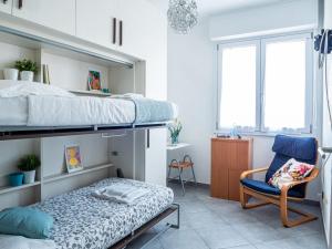 a bedroom with a bunk bed and a chair at The Best Rent - Modern two rooms apartment with balcony in Milan