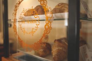 a display case with various types of bread at Hotel Posta in Cecina