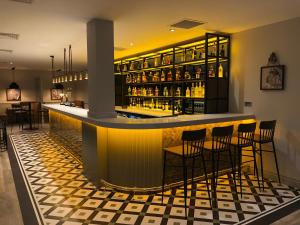 a bar in a restaurant with chairs and bottles of alcohol at The Aberdeen Altens Hotel in Aberdeen