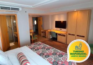 a hotel room with a television and a bed at Lets Idea Brasília Hotel in Brasília