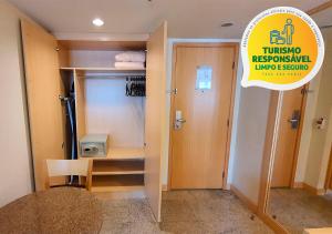 
a bathroom with a sink, toilet and a door at Lets Idea Brasília Hotel in Brasília
