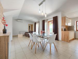a kitchen and dining room with a table and chairs at Holiday Home Florens - ROJ469 by Interhome in Sveti Petar u Šumi