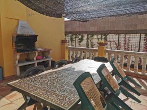 a dining room with a table and chairs on a balcony at Joanet Guarda turismo familiar en plena naturaleza in La Guardiola