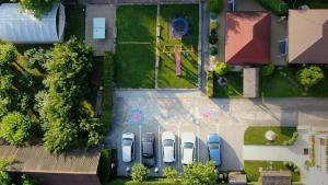 an overhead view of three cars parked in a yard at Pensiune Diana in Baile Felix