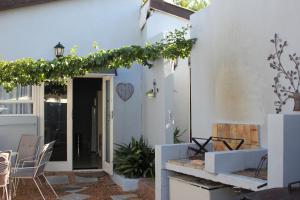 a patio with chairs and a door to a house at 25 on Fitzpatrick in Parow