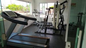 a gym with several tread machines in a room at Hotel Lopes in Cubatão