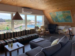 a living room with couches and a large window at Pakhuset Anholt in Anholt