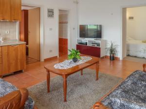 a living room with a coffee table and a tv at Holiday Home Marija by Interhome in Vicani +49 photos