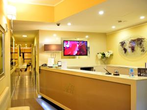 a hotel lobby with a reception counter and a room at Hotel Ferton in Milan