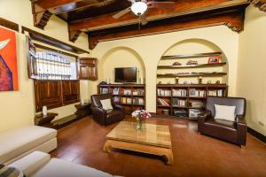 a living room with a couch and chairs and a table at Hotel Flor De Sarta in León