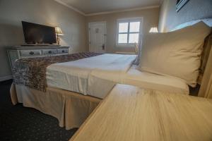 a hotel room with a large bed and a window at Marina Bay Resort in Fort Walton Beach